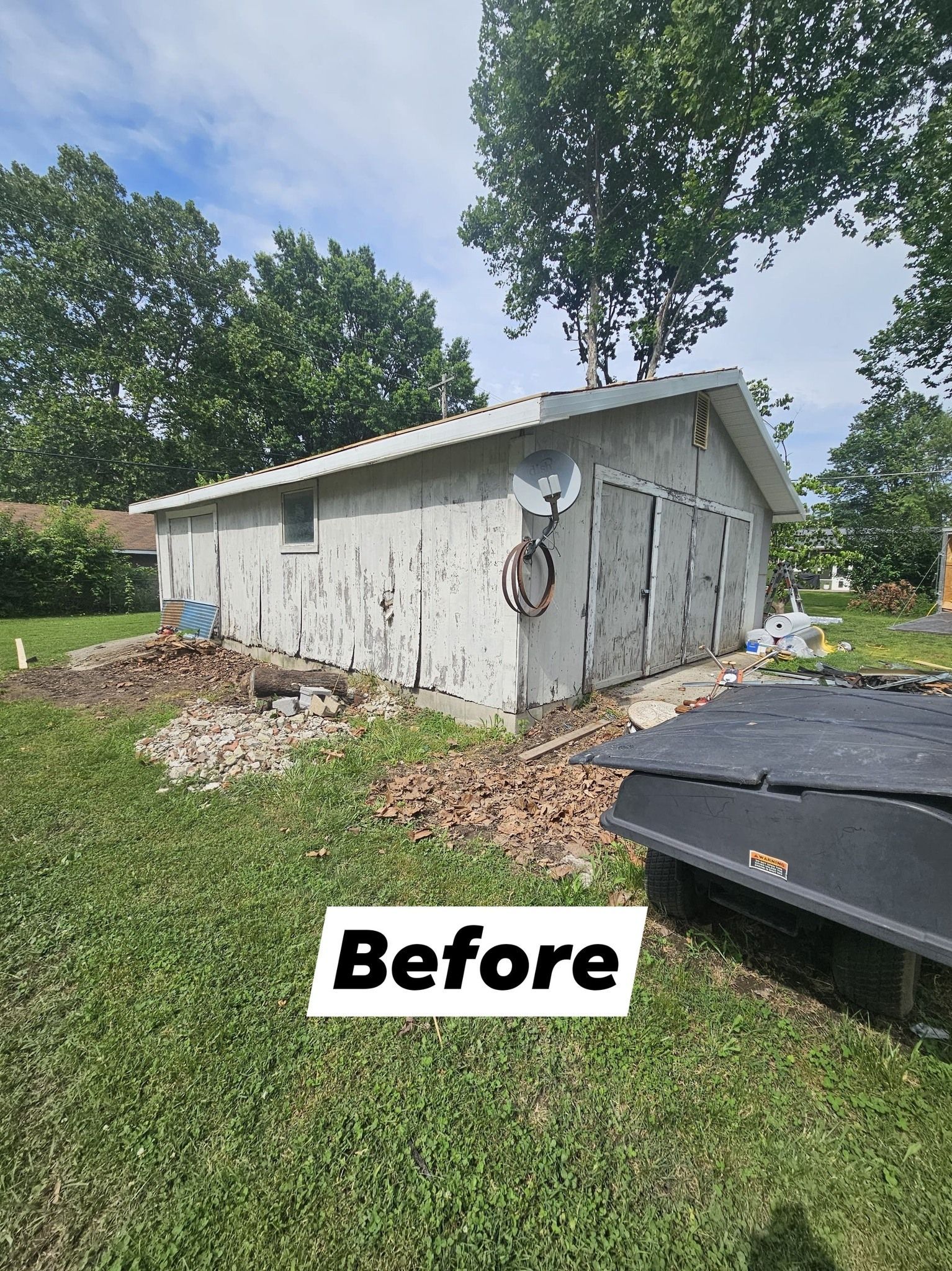 Dilapidated concrete building with peeling paint, surrounded by dirt and grass, marked 